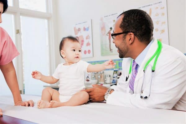doctor checking baby for acne